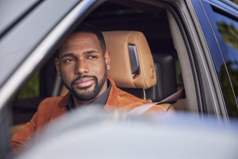 Man looking out car window