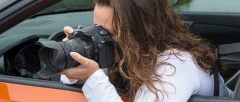 Photographer taking pictures from the car